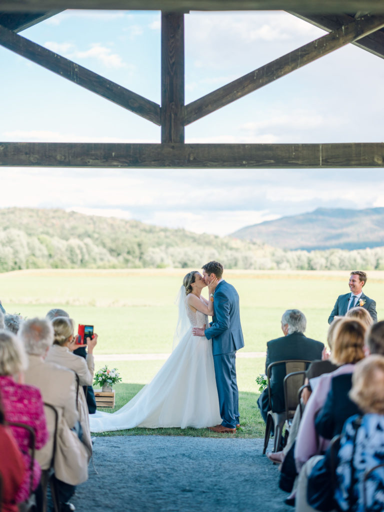 Couple kissing at their outdoor wedding venue in Vermont